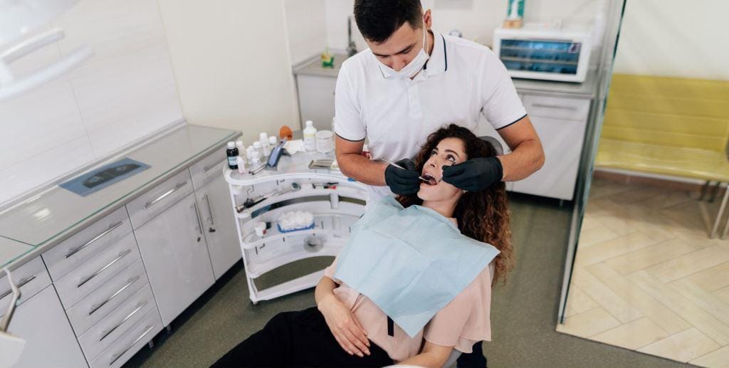 Dentysta badający pacjenta w gabinecie